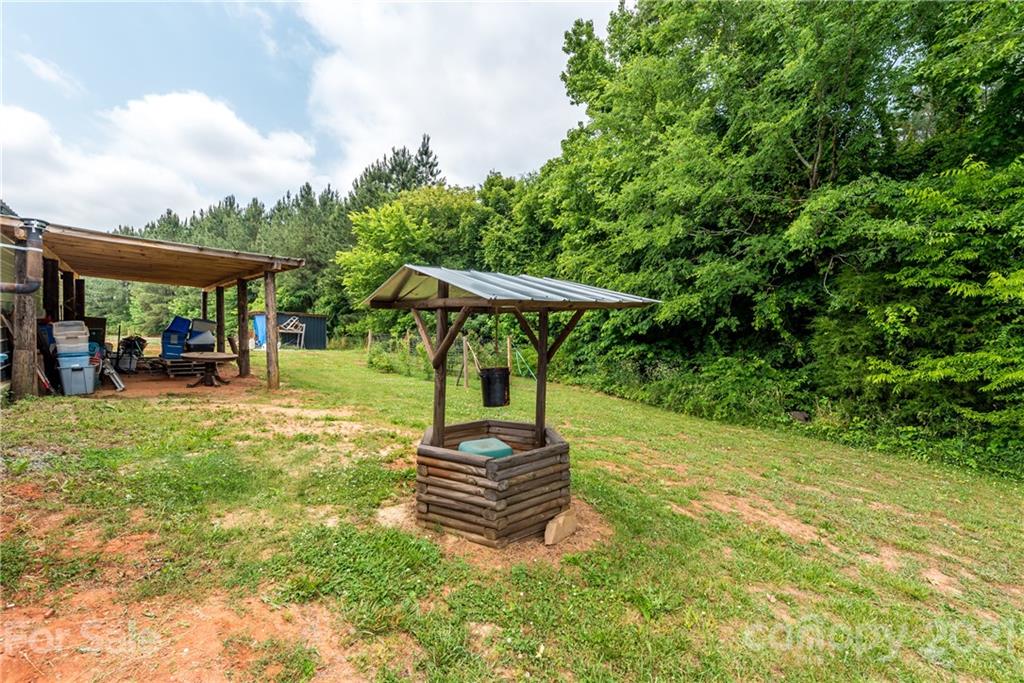 4638 Barrier Road Concord, NC 28025 - Photo 33 of 43 a backyard of a house with barbeque oven table and chairs