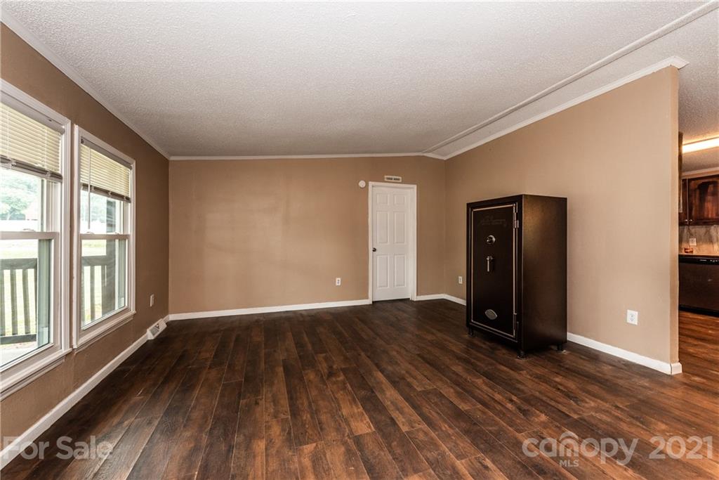 4638 Barrier Road Concord, NC 28025 - Photo 5 of 43 a view of an empty room with wooden floor and a window