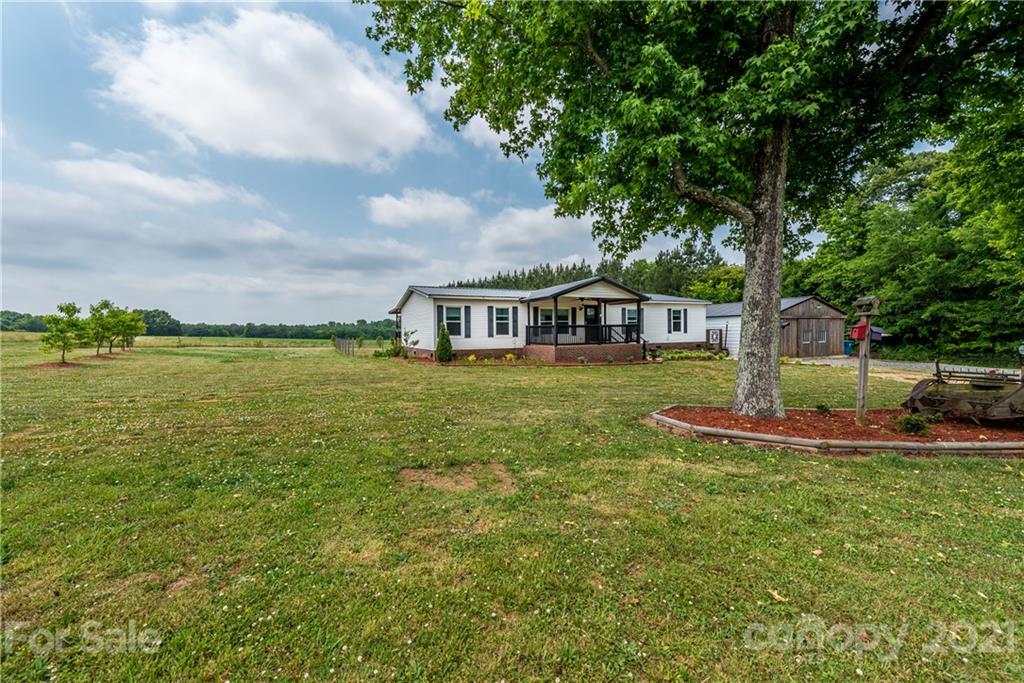 4638 Barrier Road Concord, NC 28025 - Photo 43 of 43 a view of a house with a big yard and large trees