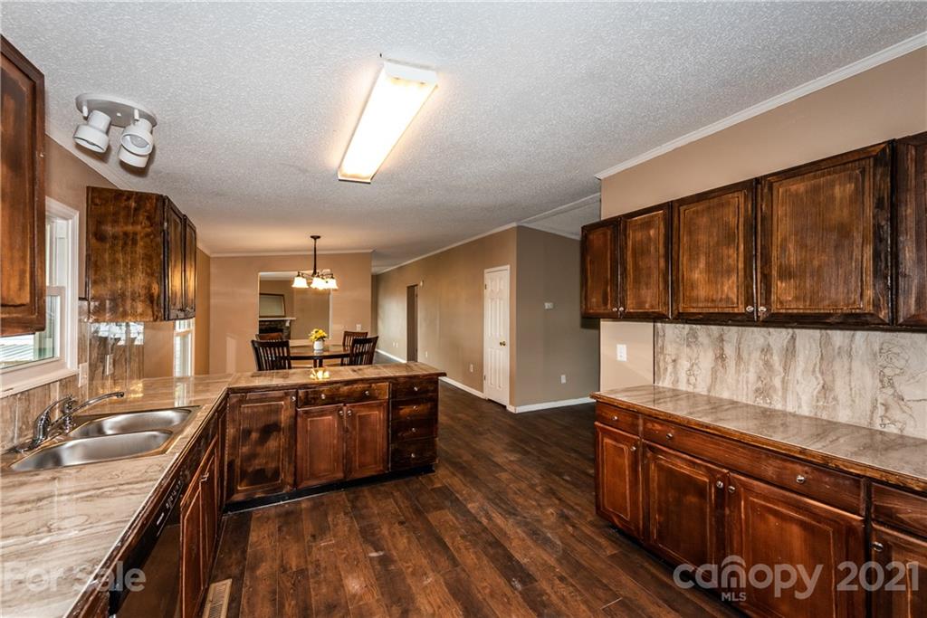 4638 Barrier Road Concord, NC 28025 - Photo 10 of 43 a large kitchen with stainless steel appliances granite countertop a stove and a large window