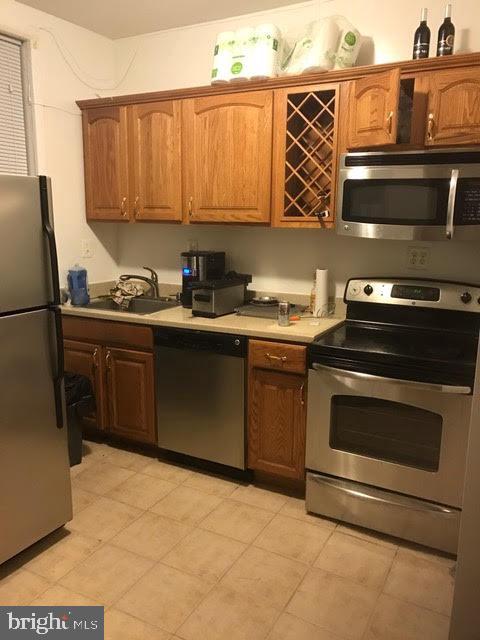11 N Street Northwest Washington, DC 20001 - Photo 7 of 17 a kitchen with stainless steel appliances a stove a sink and a microwave