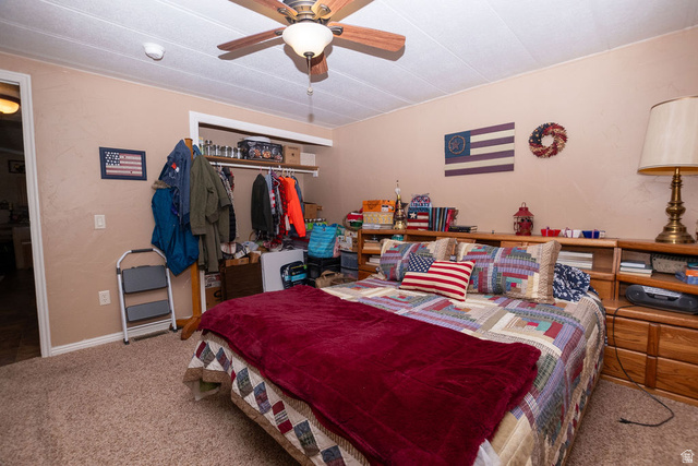 855 East 300 N Street Beaver, UT 84713 - Photo 30 of 44 Bedroom featuring a ceiling fan with light fixture, textured beige walls, and carpet flooring