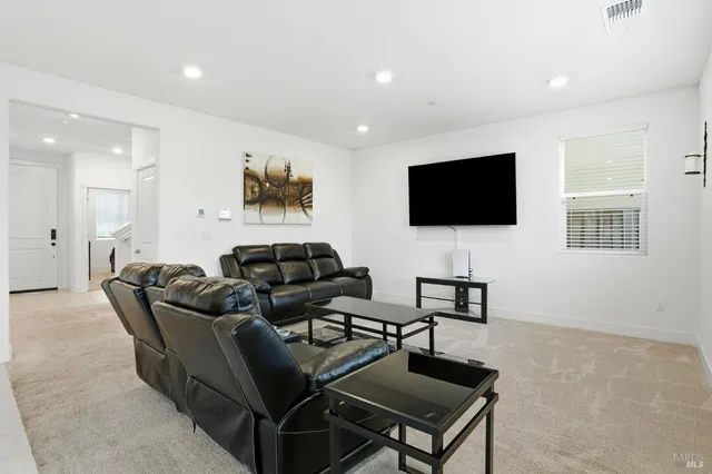 a living room with furniture kitchen view and a kitchen