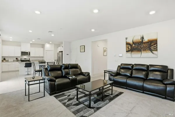 a kitchen with stainless steel appliances granite countertop a refrigerator and a stove top oven