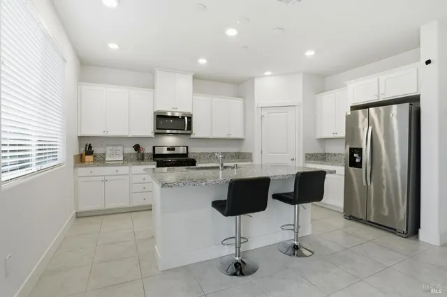 a dining room with furniture and a window