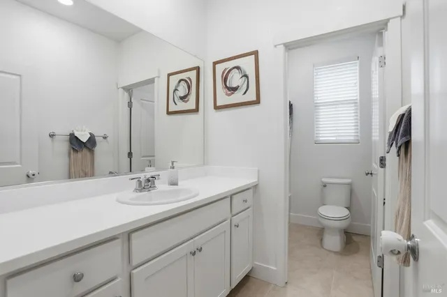 a white toilet sitting next to a bath tub shower