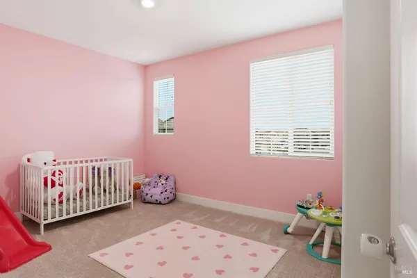 a spacious bedroom with a bed and a tv