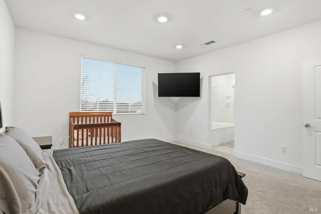 a bathroom with a tub a sink and a large mirror