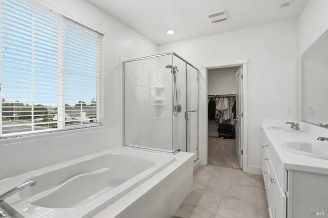 a bathroom with a tub and a window