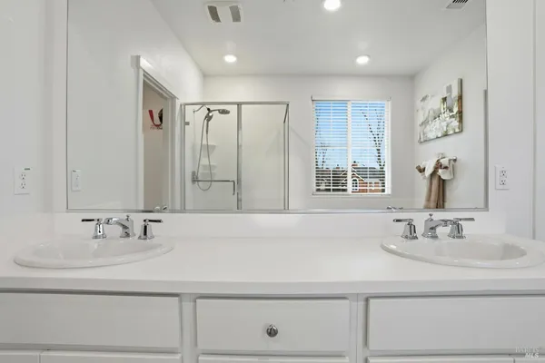 a white toilet sitting next to a shower