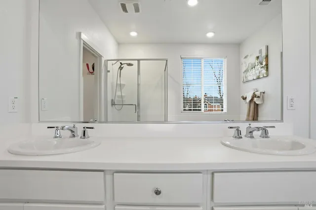 a white toilet sitting next to a shower
