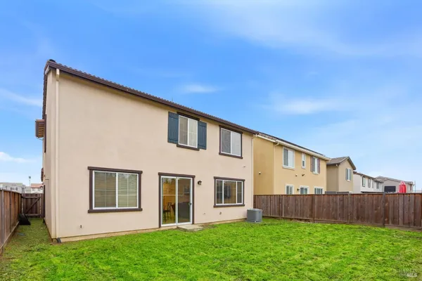 a aerial view of multi story residential apartment building with yard