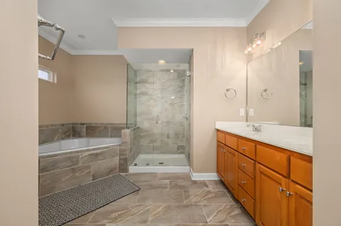 a bathroom with a granite countertop sink a toilet a mirror and shower