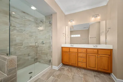 a bathroom with a shower a sink and a mirror