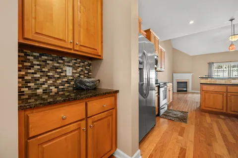 a kitchen with a refrigerator and a stove