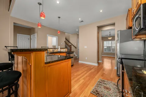 a view of kitchen with furniture and wooden floor