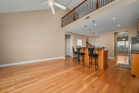 a view of a kitchen with a dining table chairs and wooden floor