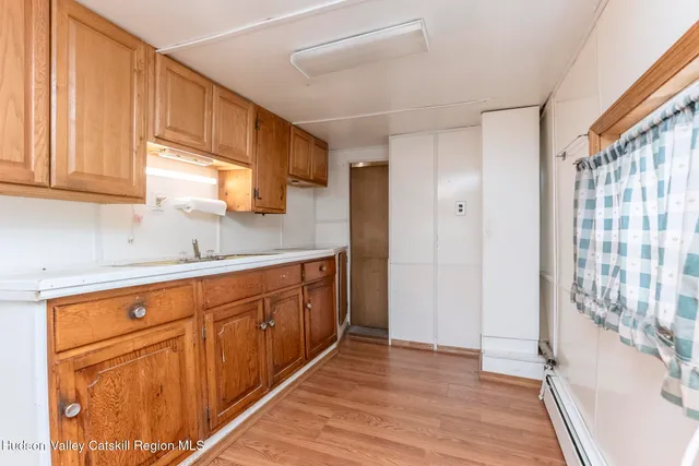 a kitchen with wooden cabinets and sink