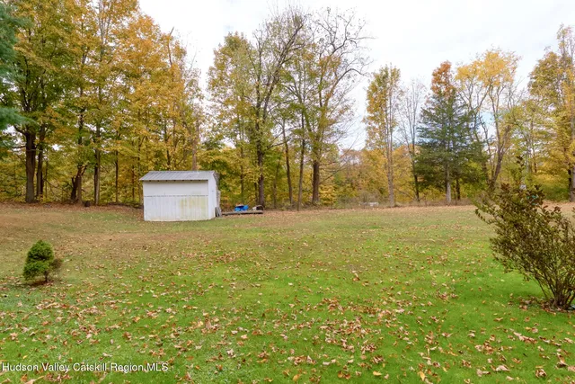 a view of a house with a yard and garage
