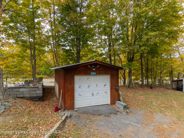 an aerial view of residential houses with outdoor space and trees