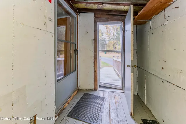 a view of a livingroom with entryway stairs and furniture
