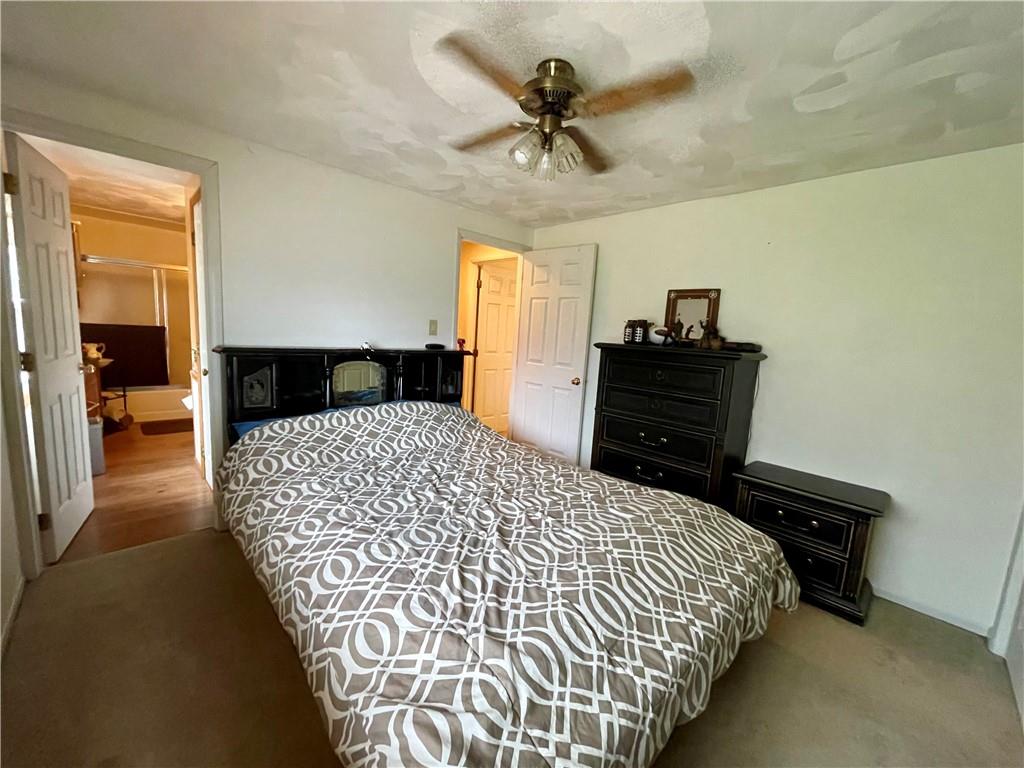 112 Mechling Road Kittanning, PA 16201 - Photo 10 of 25 a bedroom with a bed and a chandelier