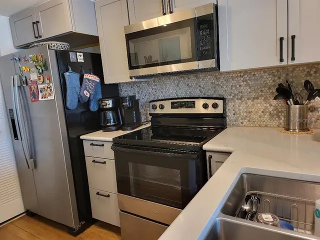 a kitchen with a sink a counter space and a dining table