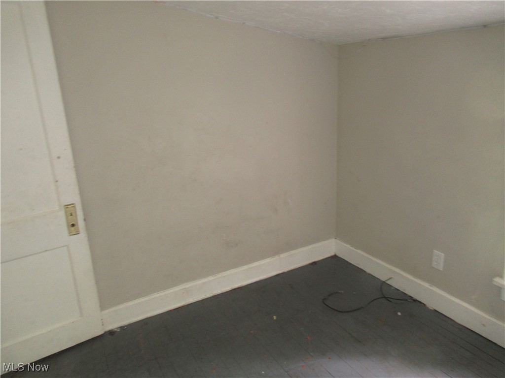 4482 Liberty Road Cleveland, OH 44121 - Photo 14 of 44 Empty room featuring hardwood / wood-style floors and a textured ceiling