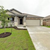 a view of a house with backyard and garden