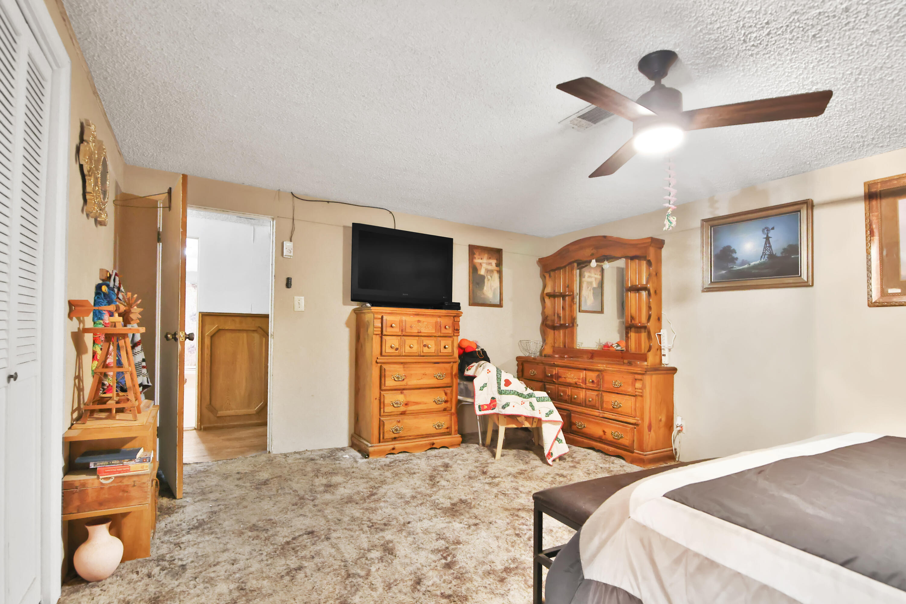 1211 140th Street Lubbock, TX 79423 - Photo 21 of 48 a bedroom with furniture and a flat screen tv