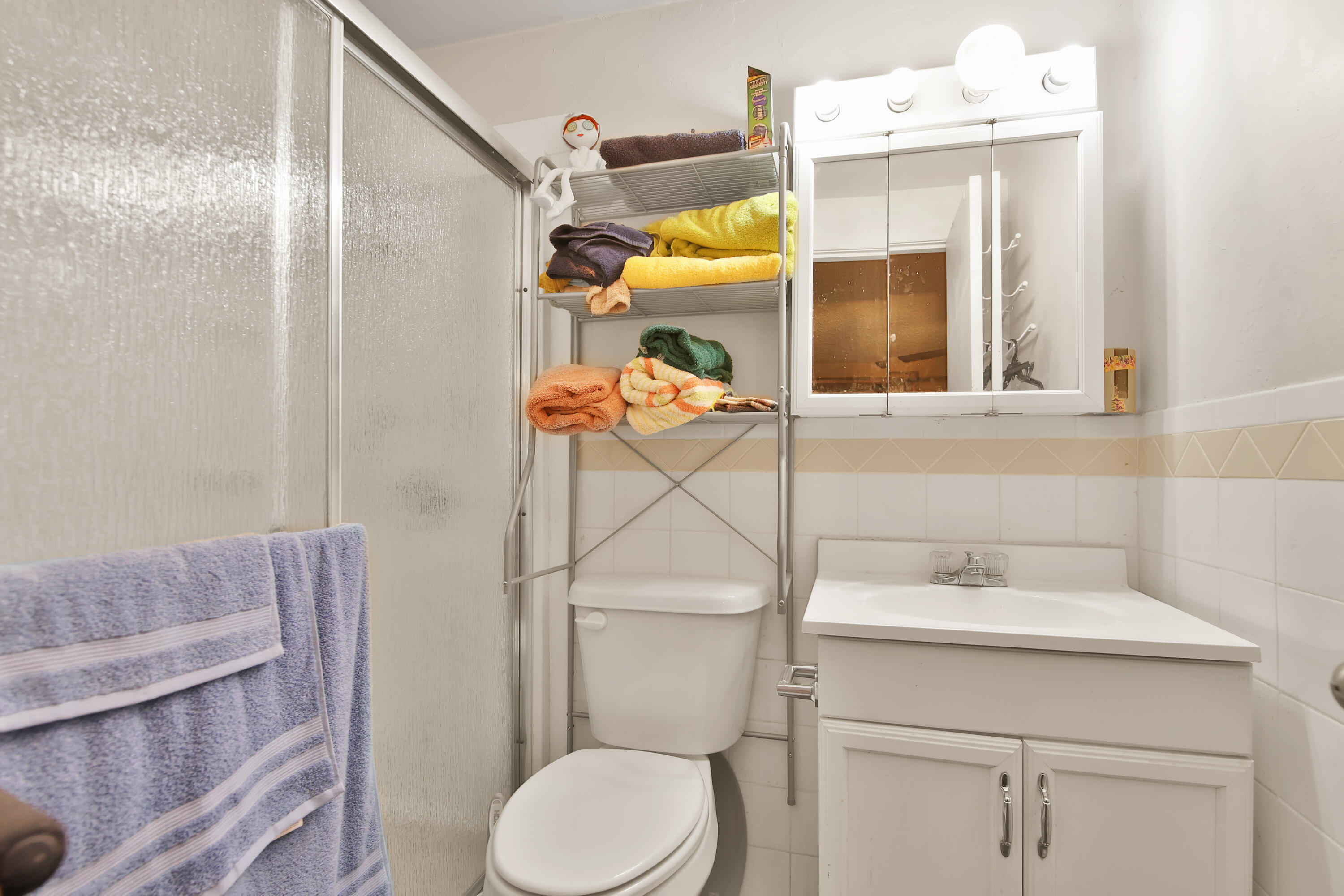 1211 140th Street Lubbock, TX 79423 - Photo 23 of 48 a bathroom with a sink a toilet and shower