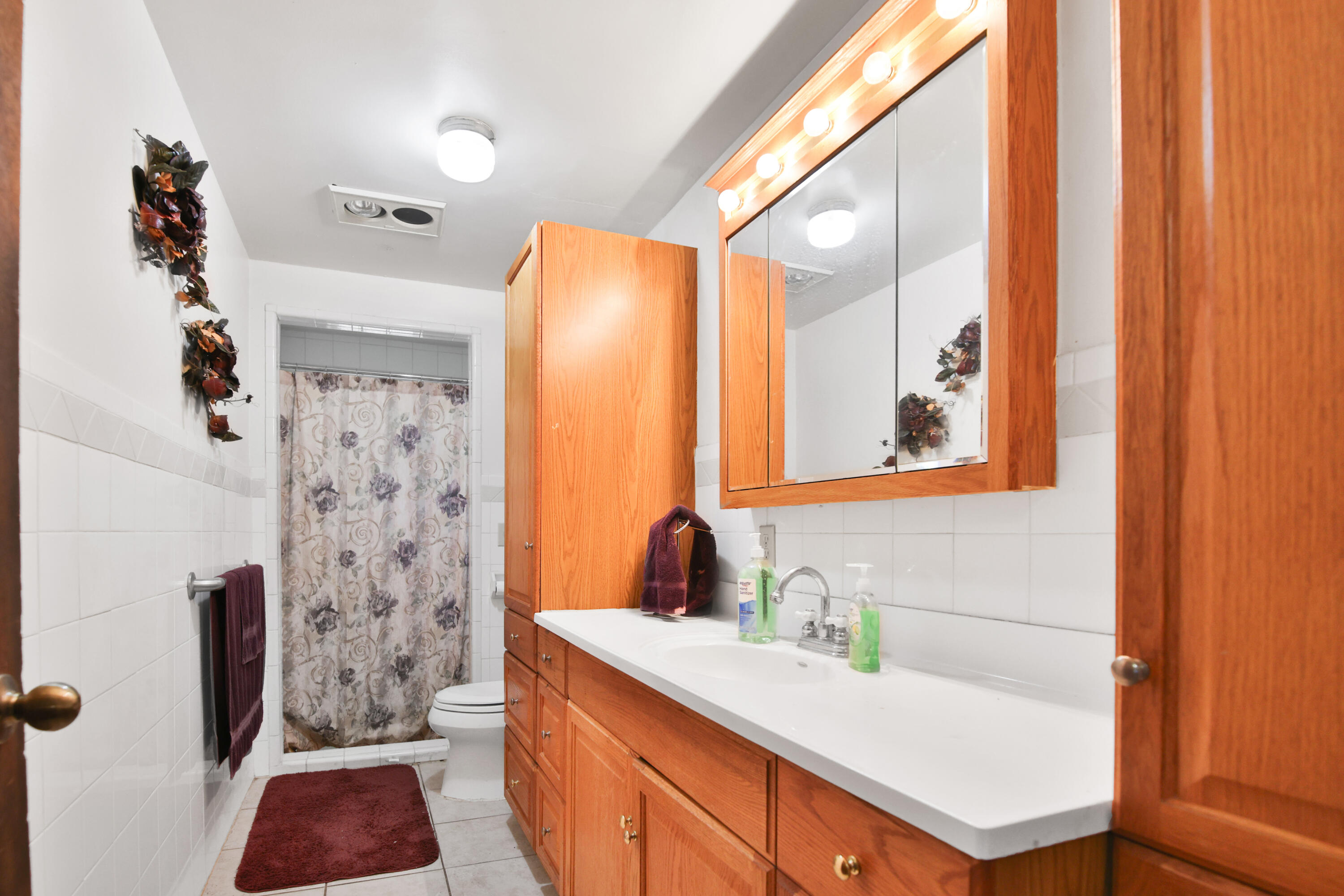 1211 140th Street Lubbock, TX 79423 - Photo 24 of 48 a bathroom with a sink and a mirror