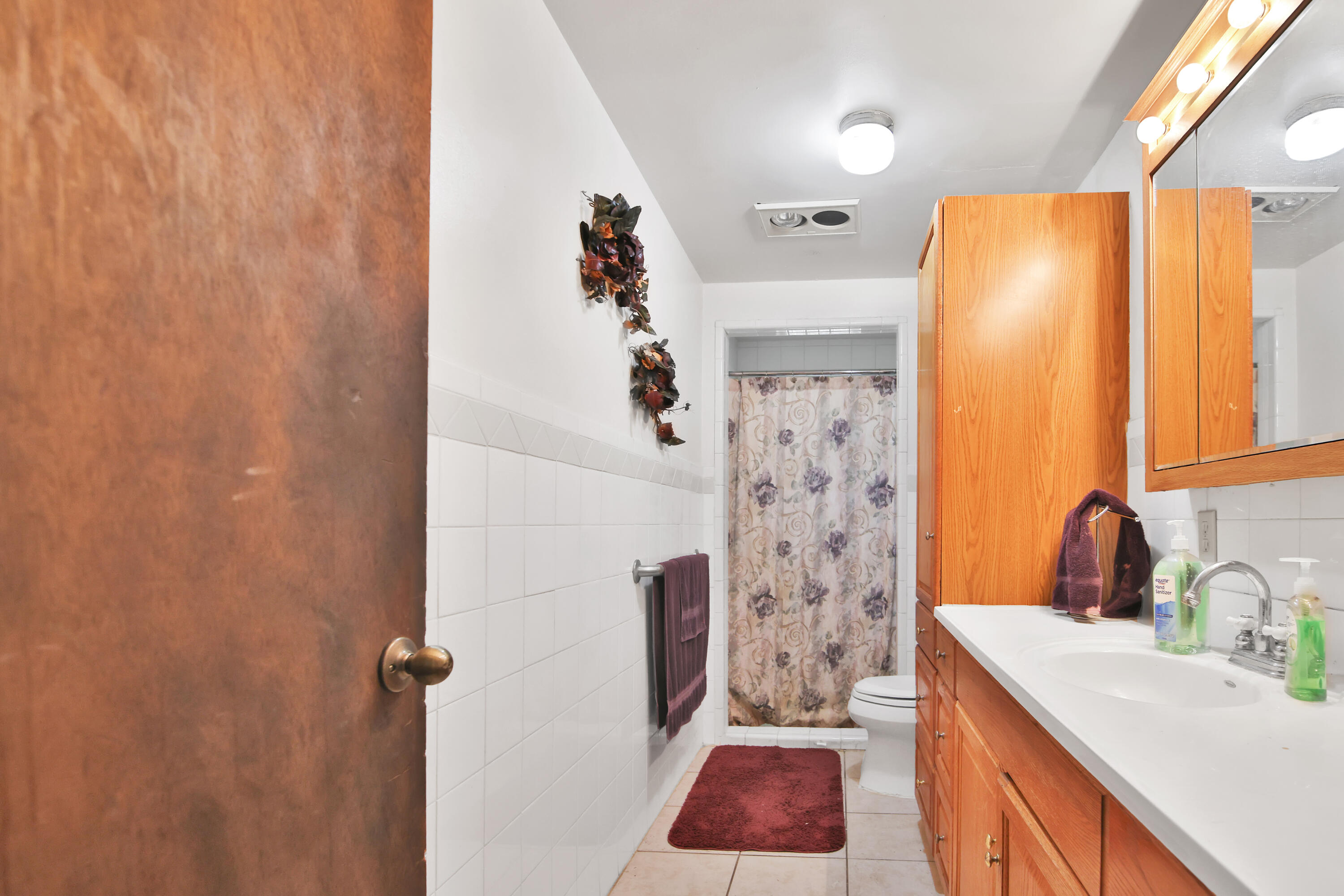 1211 140th Street Lubbock, TX 79423 - Photo 25 of 48 a bathroom with a sink a toilet and shower curtain