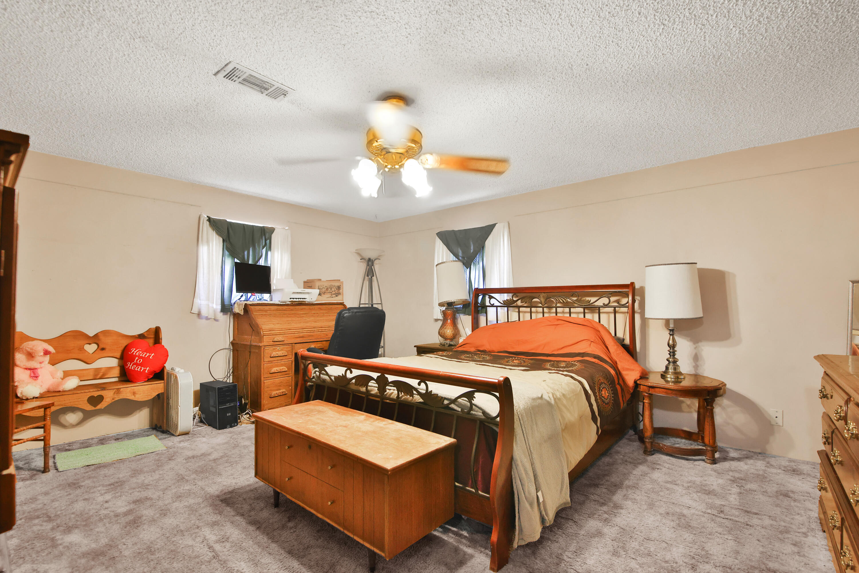 1211 140th Street Lubbock, TX 79423 - Photo 26 of 48 a bedroom with a bed and a chandelier