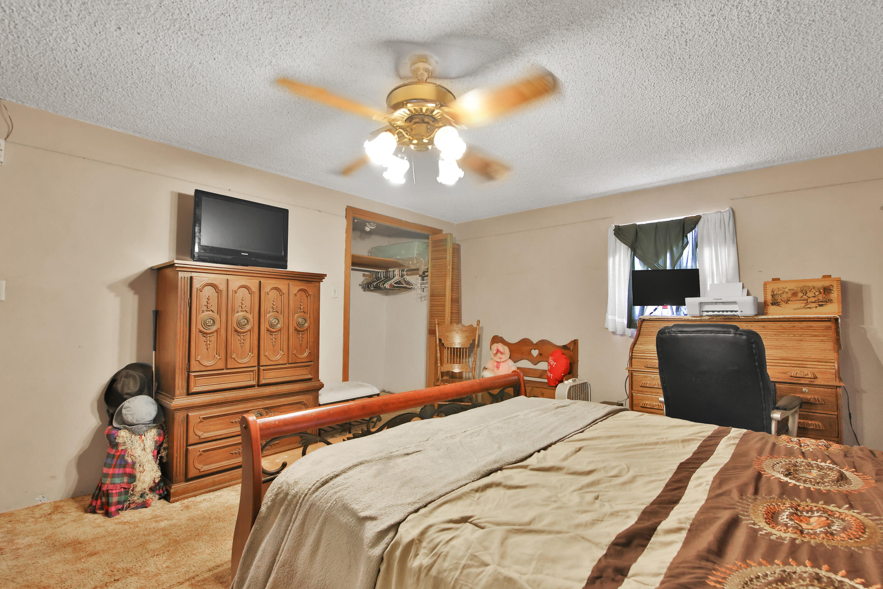 1211 140th Street Lubbock, TX 79423 - Photo 27 of 48 a bedroom with a bed and a chandelier