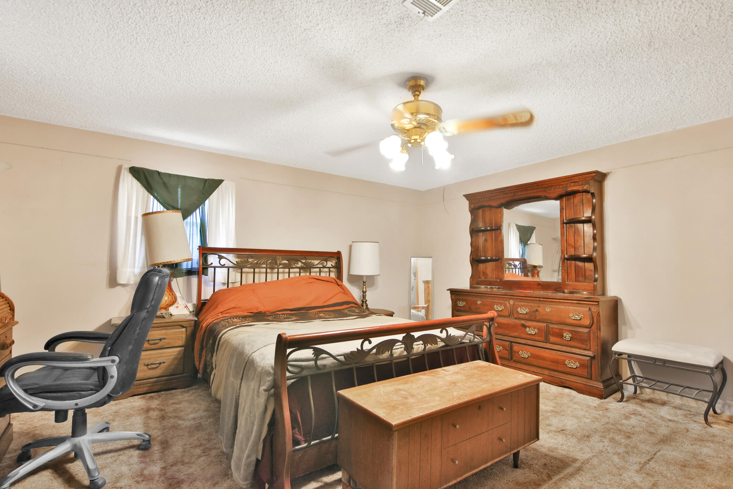 1211 140th Street Lubbock, TX 79423 - Photo 28 of 48 a bedroom with a bed a chandelier and closet