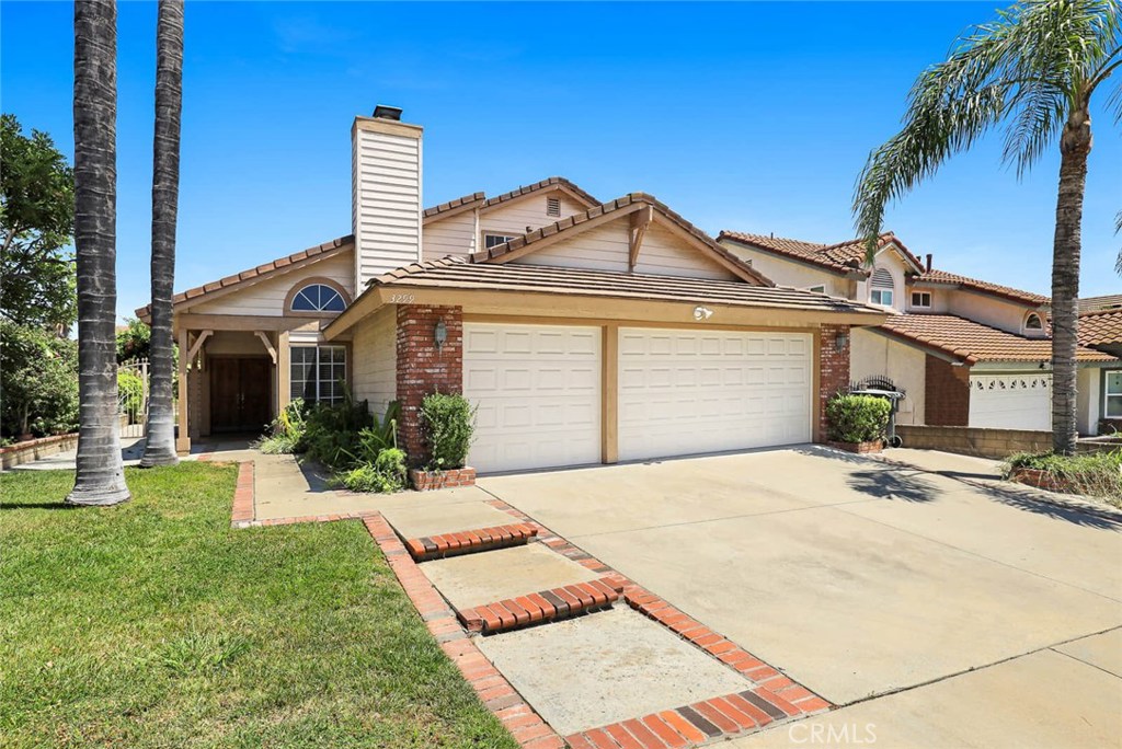 3299 Royal Ridge Road Chino Hills, CA 91709 - Photo 1 of 1 a front view of a house with a garden and yard