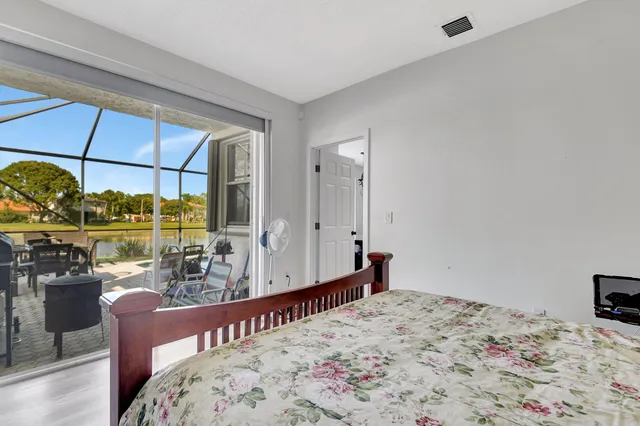 a bed sitting in a bedroom next to a window