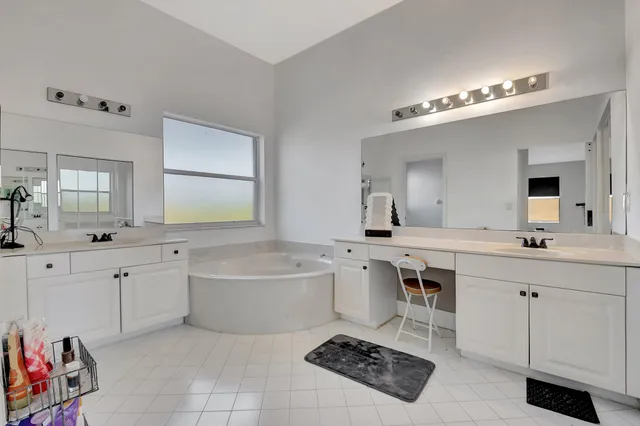 a spacious bathroom with a sink double vanity and a tub