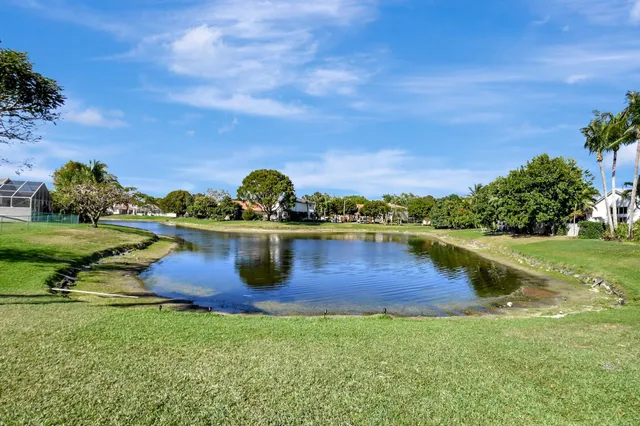 a view of a lake with a house in the background