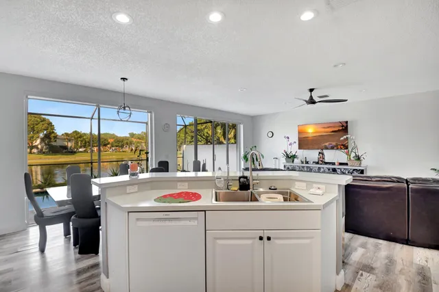 a kitchen with a sink a stove and cabinets