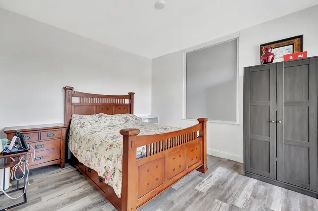 a bedroom with bed and a window