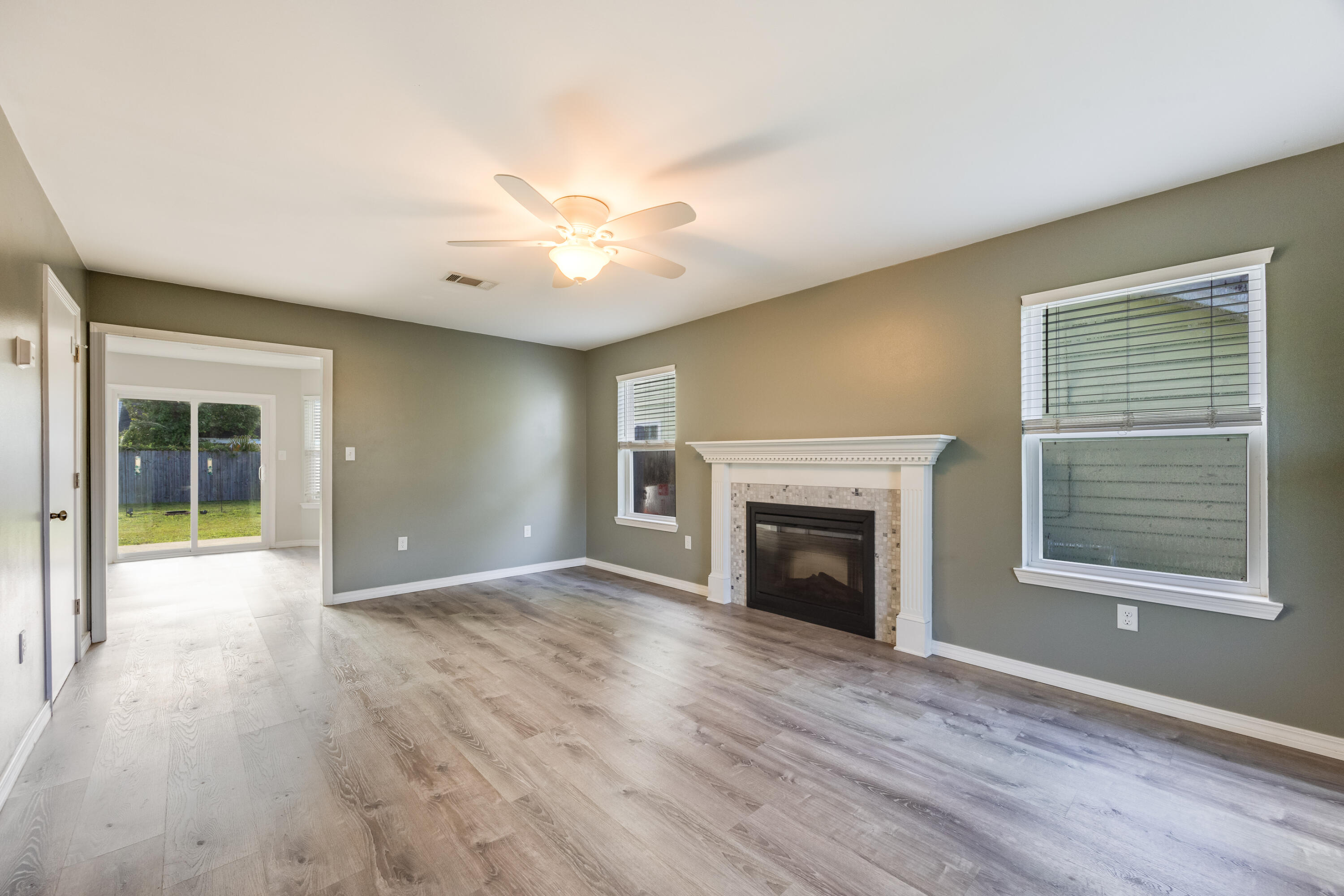 475 Sandy Ridge Circle Mary Esther, FL 32569 - Photo 3 of 26 wooden floor fireplace and windows in an empty room