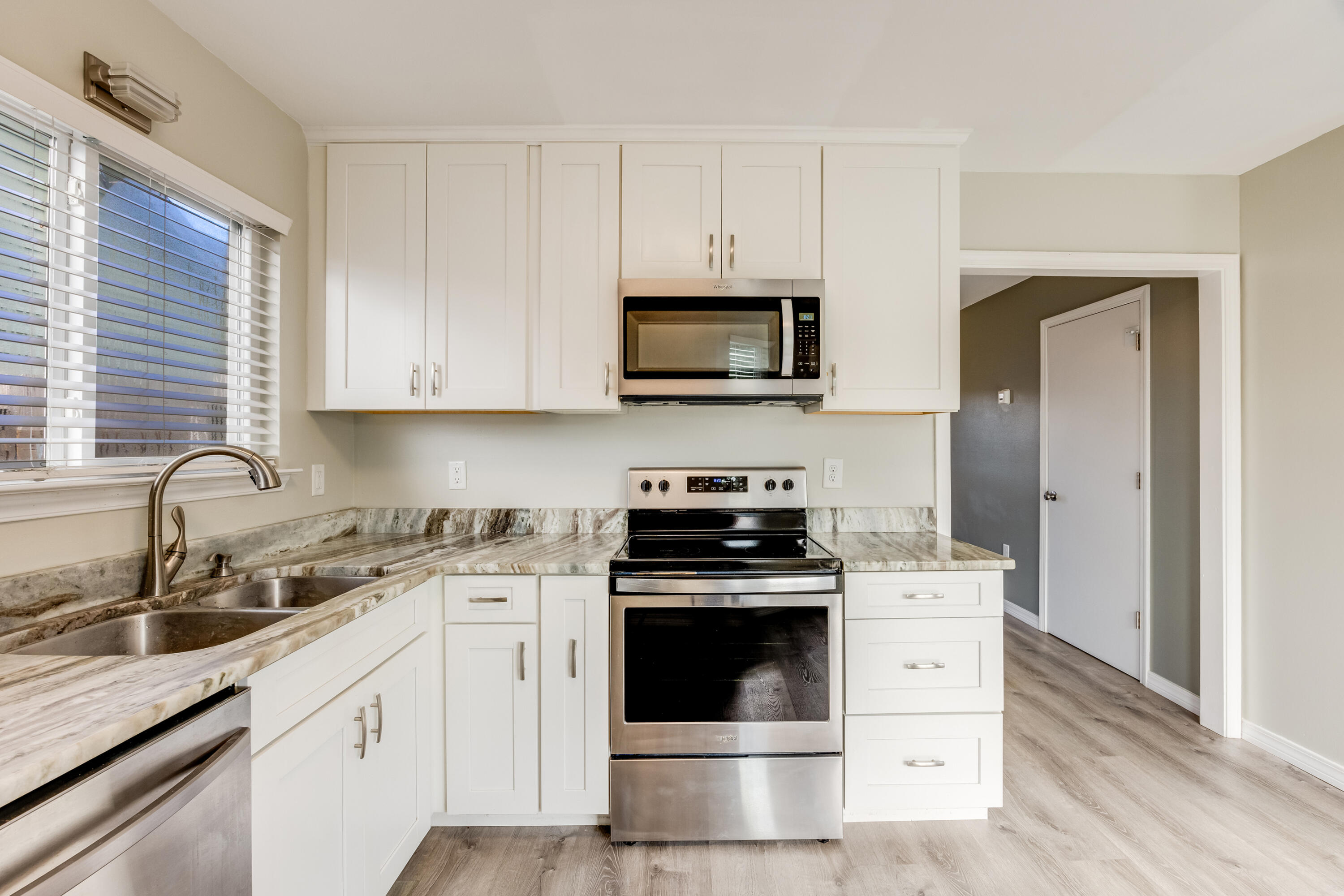 475 Sandy Ridge Circle Mary Esther, FL 32569 - Photo 8 of 26 a kitchen with cabinets stainless steel appliances a sink and wooden floor