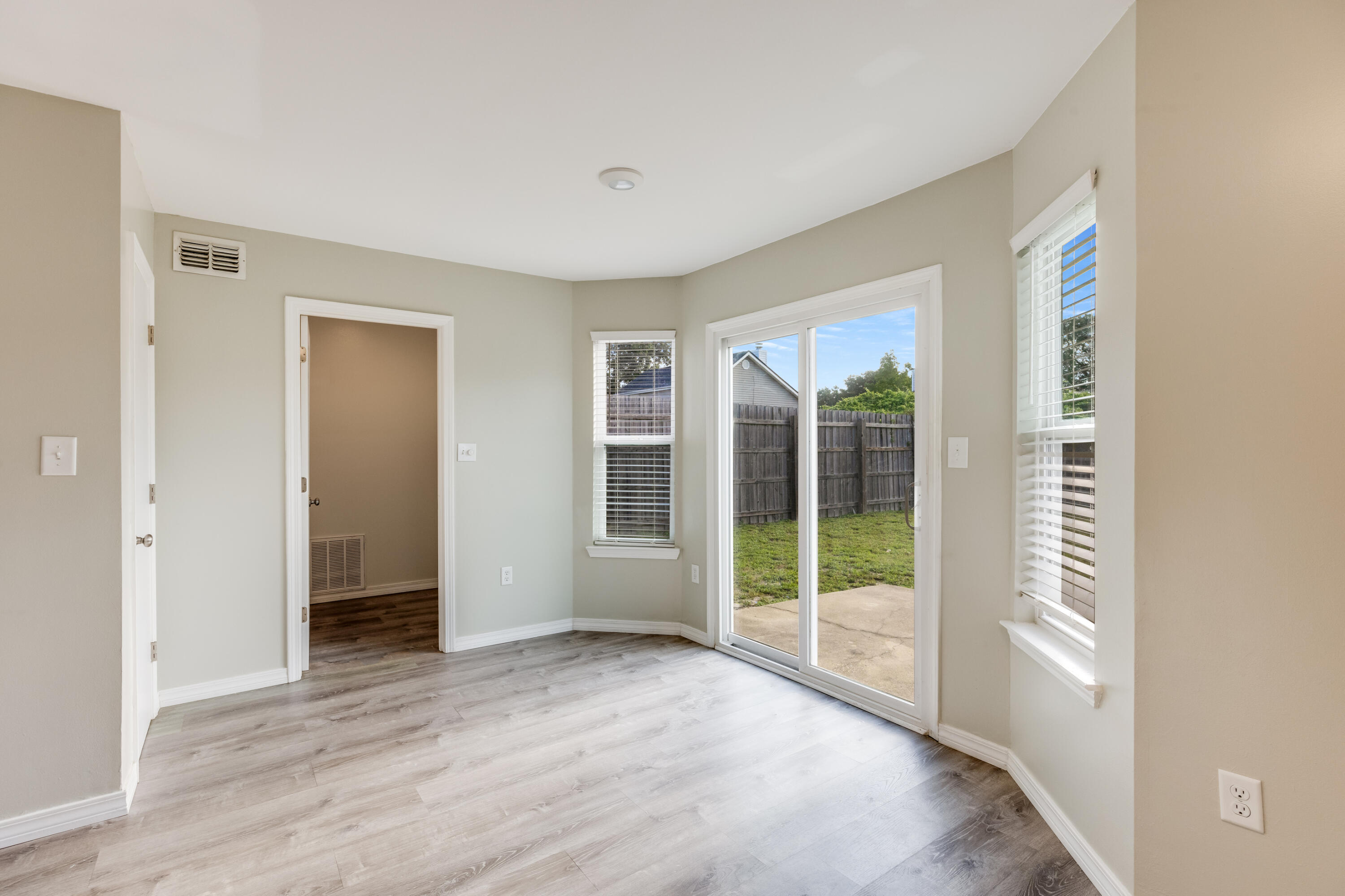 475 Sandy Ridge Circle Mary Esther, FL 32569 - Photo 9 of 26 a view of an empty room with wooden floor and a window