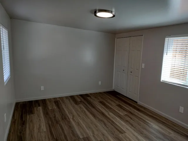 a view of a room with wooden floor and a sink