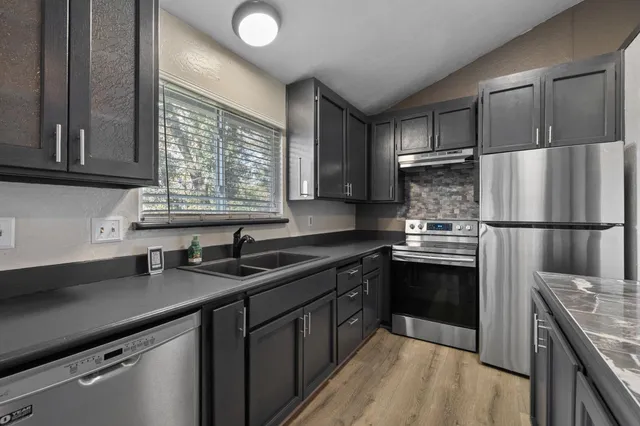 a kitchen with a sink stove and refrigerator