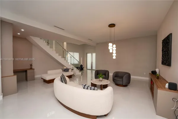 a view of a livingroom with furniture and a flat screen tv