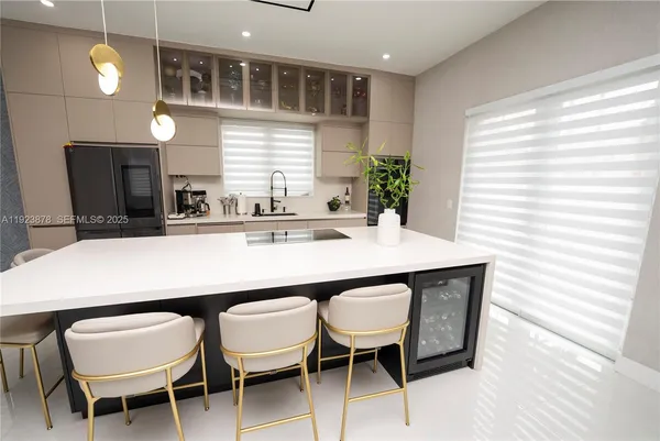 a kitchen with a dining table and chairs