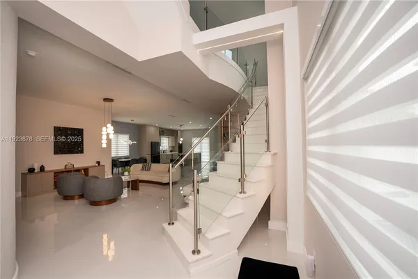 a view of entryway and hall with wooden floor